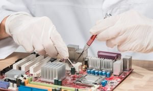 Repairmen using laptop workshop
